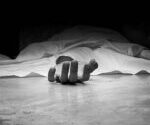 The dead man's body. Focus on hand
